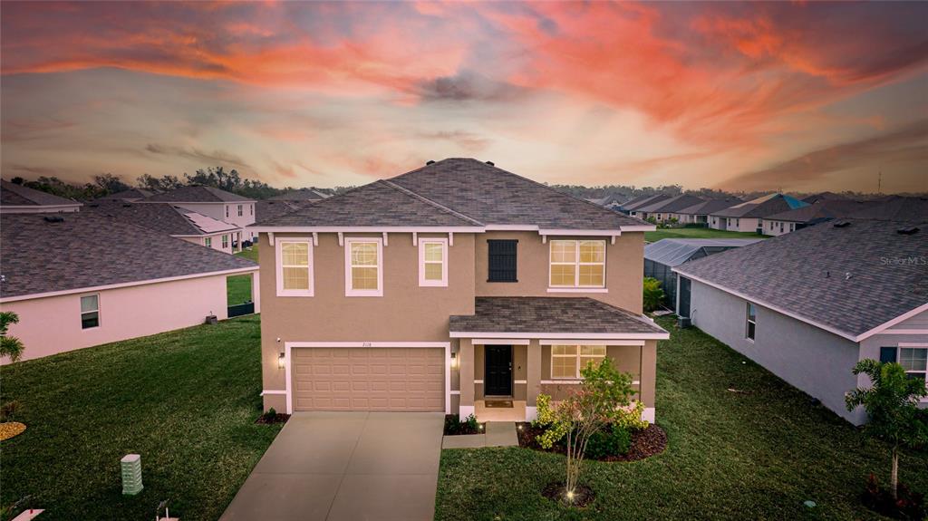 a aerial view of a house with a yard