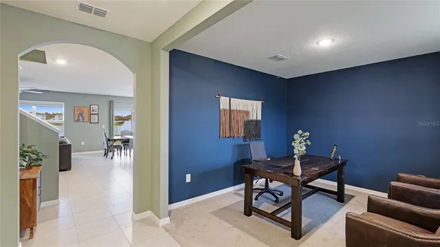 a kitchen with stainless steel appliances kitchen island granite countertop a refrigerator and a sink