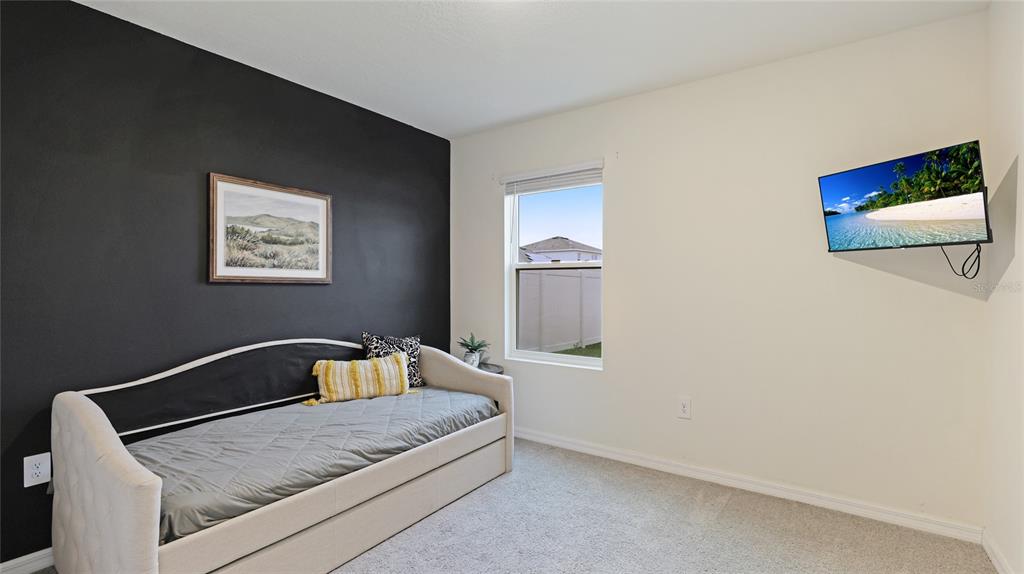 2118 Grand Flora Trail Bradenton, FL 34208 - Photo 31 of 67 a bedroom with a bed and lamp