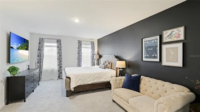 a bedroom with bed and a couch