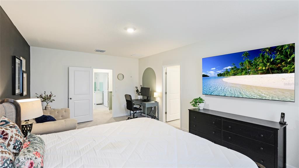 2118 Grand Flora Trail Bradenton, FL 34208 - Photo 38 of 67 a bedroom with a bed and a potted plant