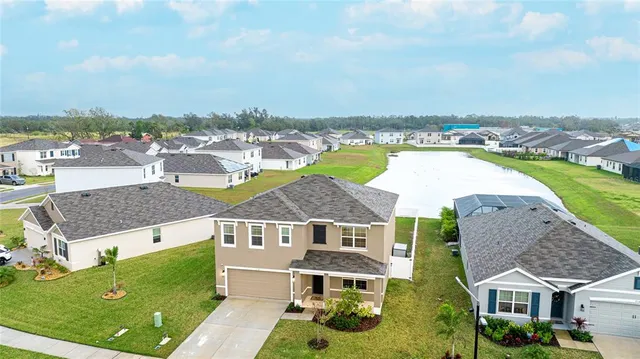 an aerial view of residential houses with outdoor space and swimming pool