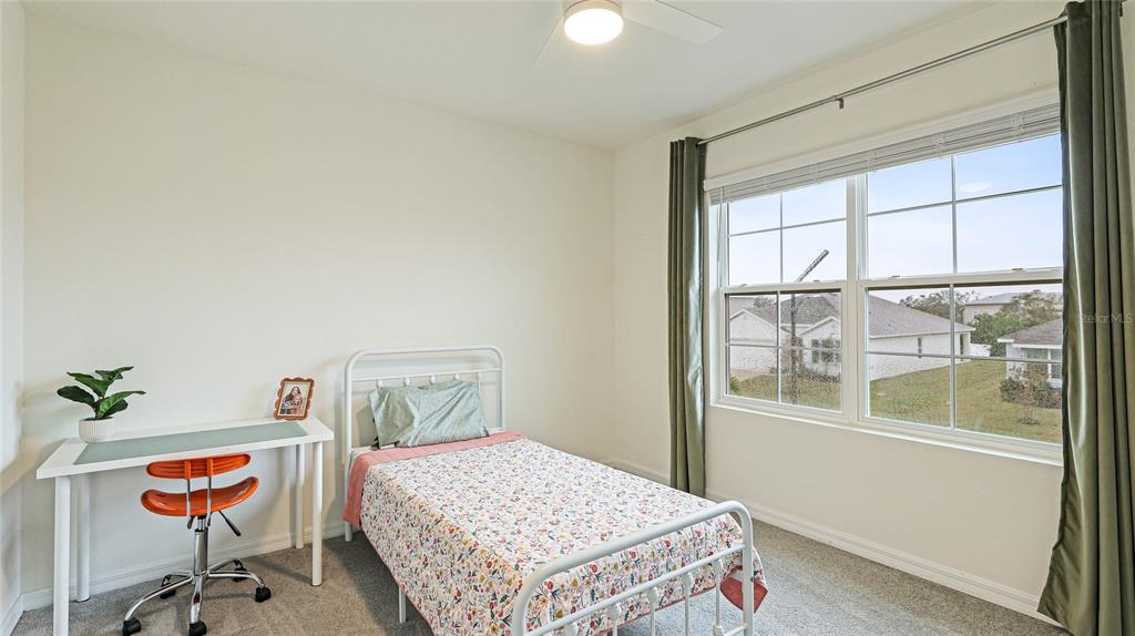 2118 Grand Flora Trail Bradenton, FL 34208 - Photo 42 of 67 a bedroom with a bed and a window