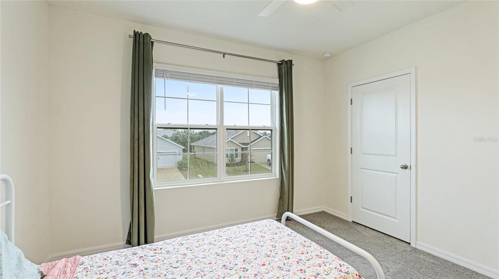 2118 Grand Flora Trail Bradenton, FL 34208 - Photo 43 of 67 a bedroom with a bed and a window