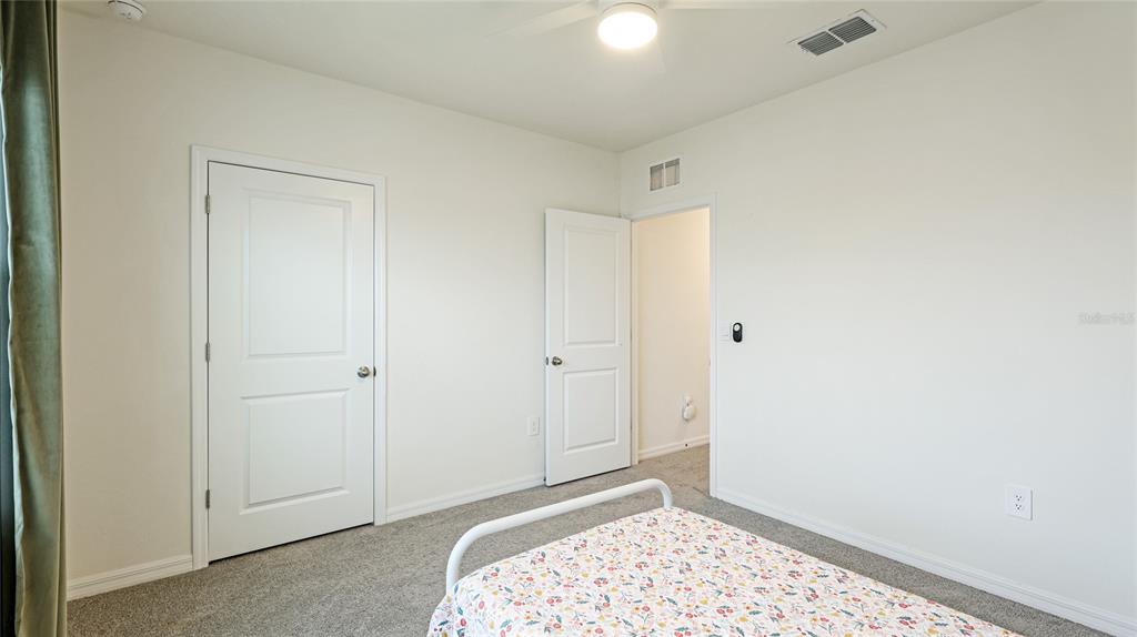 2118 Grand Flora Trail Bradenton, FL 34208 - Photo 44 of 67 a bedroom with a bed and a sink