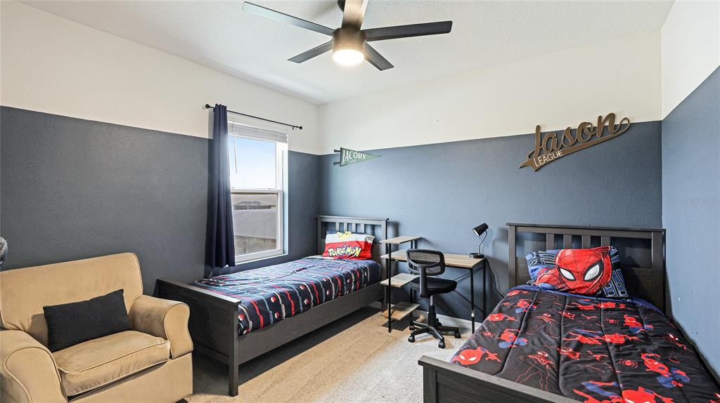 2118 Grand Flora Trail Bradenton, FL 34208 - Photo 47 of 67 a bedroom with bed and a couch