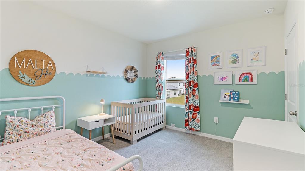 2118 Grand Flora Trail Bradenton, FL 34208 - Photo 49 of 67 a bedroom with a bed and wooden floor