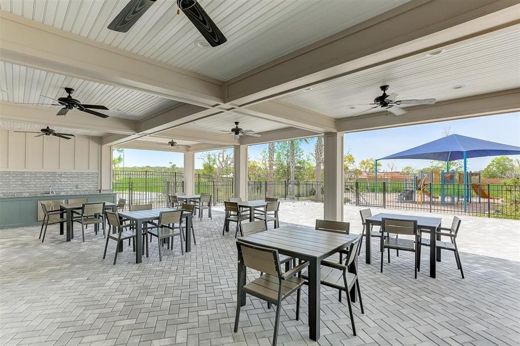 2118 Grand Flora Trail Bradenton, FL 34208 - Photo 58 of 67 a dining room with furniture a rug and a large window