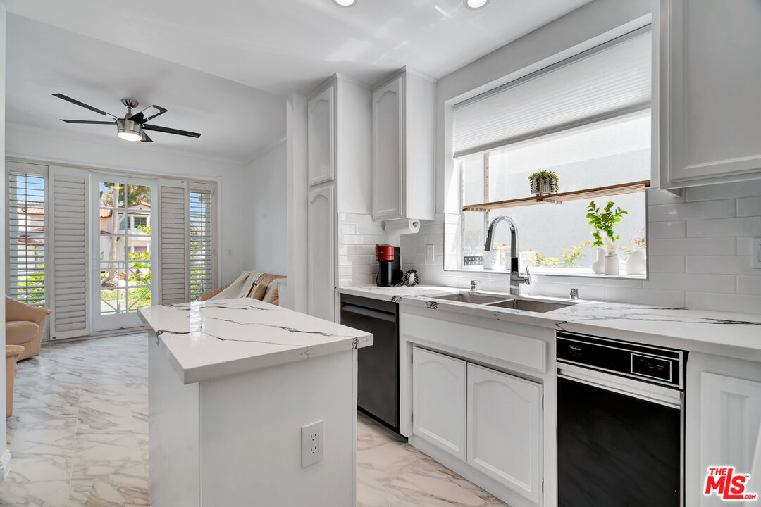 10531 Ashton Avenue, Unit 201 Los Angeles, CA 90024 - Photo 11 of 27 a kitchen with a sink stove and cabinets