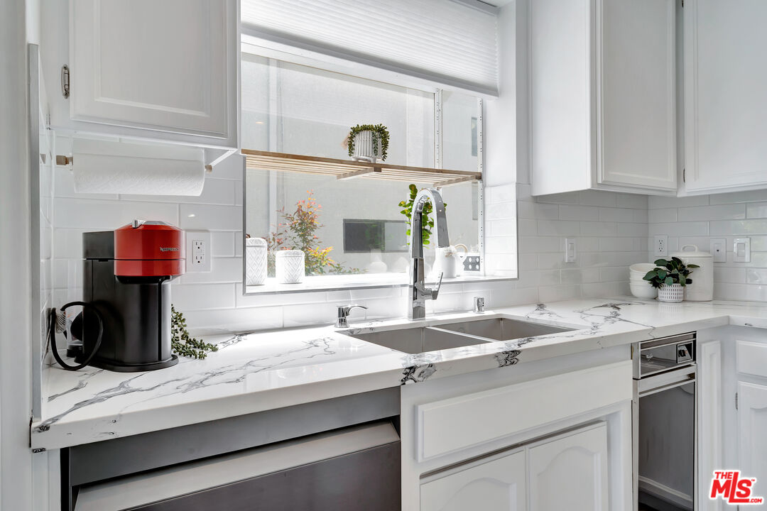 10531 Ashton Avenue, Unit 201 Los Angeles, CA 90024 - Photo 14 of 27 a kitchen with a sink and a window