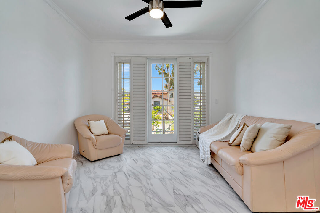 10531 Ashton Avenue, Unit 201 Los Angeles, CA 90024 - Photo 15 of 27 a living room with furniture and a window