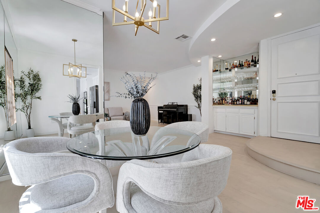 10531 Ashton Avenue, Unit 201 Los Angeles, CA 90024 - Photo 16 of 27 a dining room with furniture and wooden floor