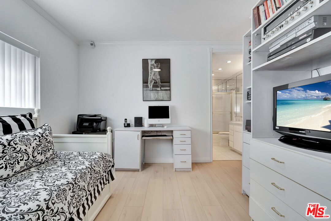 10531 Ashton Avenue, Unit 201 Los Angeles, CA 90024 - Photo 20 of 27 a living room with furniture and a flat screen tv