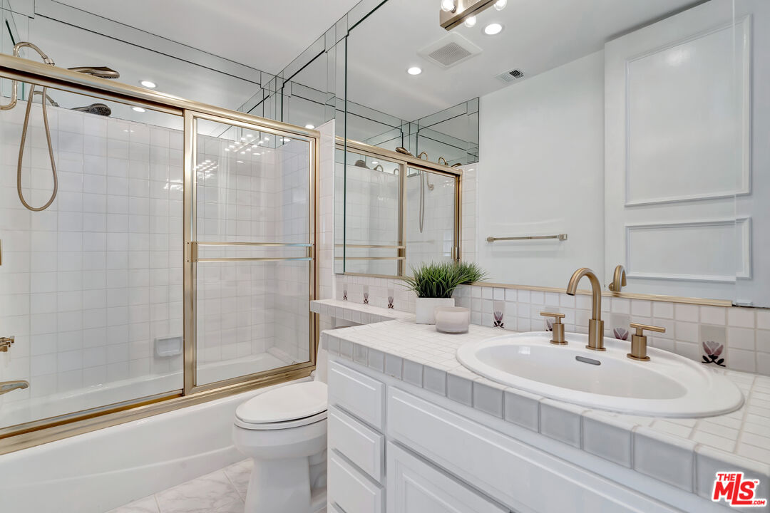 10531 Ashton Avenue, Unit 201 Los Angeles, CA 90024 - Photo 21 of 27 a bathroom with a sink toilet and shower