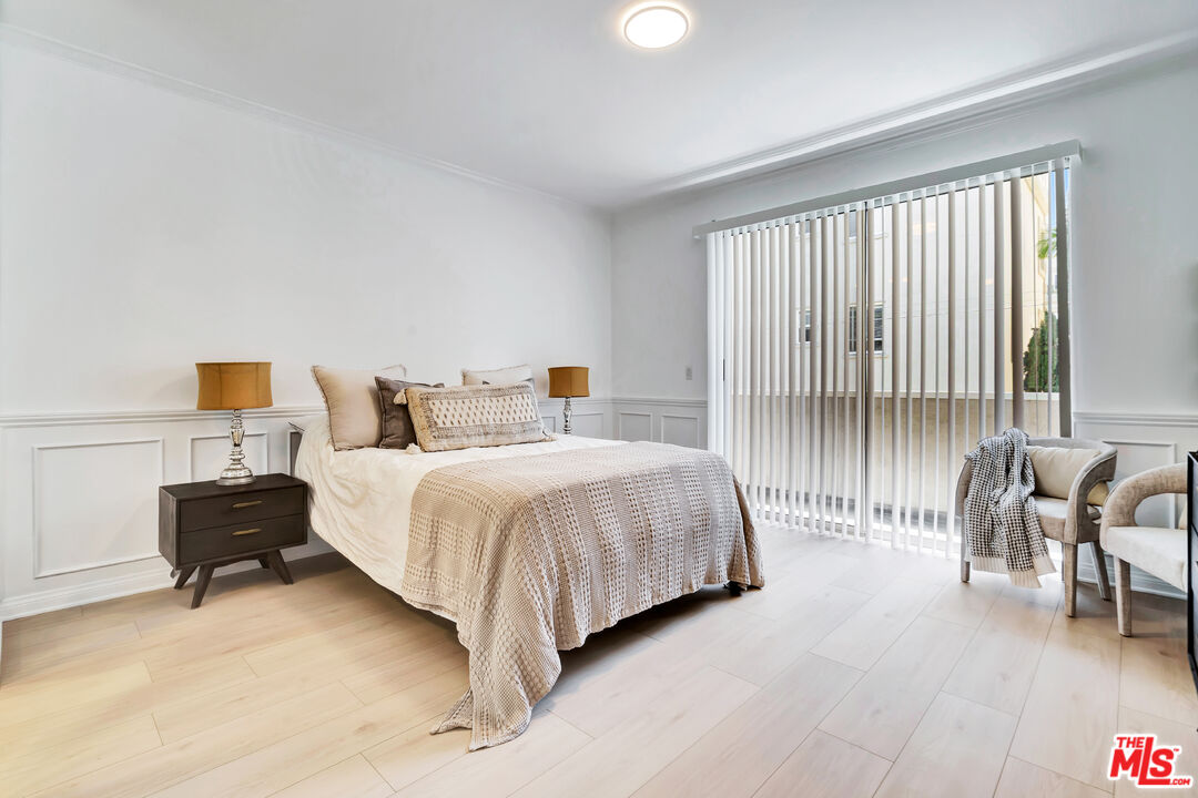 10531 Ashton Avenue, Unit 201 Los Angeles, CA 90024 - Photo 22 of 27 a bedroom with a bed and a chair