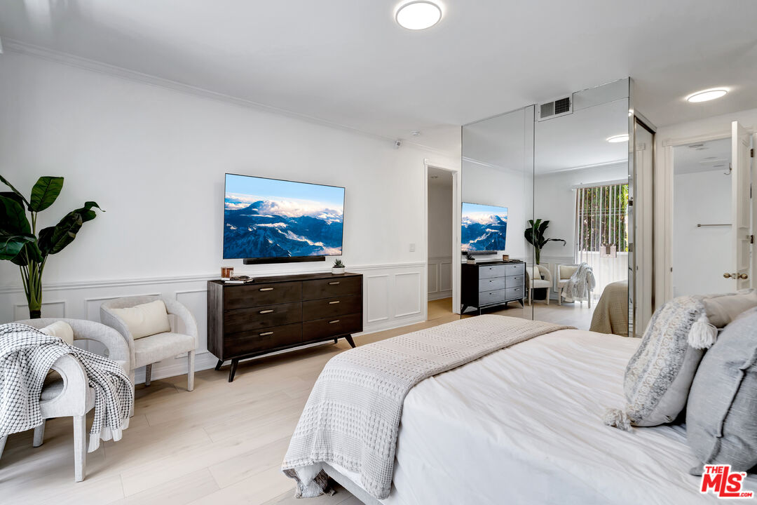 10531 Ashton Avenue, Unit 201 Los Angeles, CA 90024 - Photo 23 of 27 a bedroom with a bed and a couch