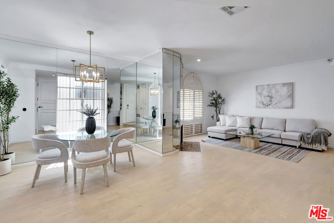 10531 Ashton Avenue, Unit 201 Los Angeles, CA 90024 - Photo 3 of 27 a living room with furniture and a chandelier
