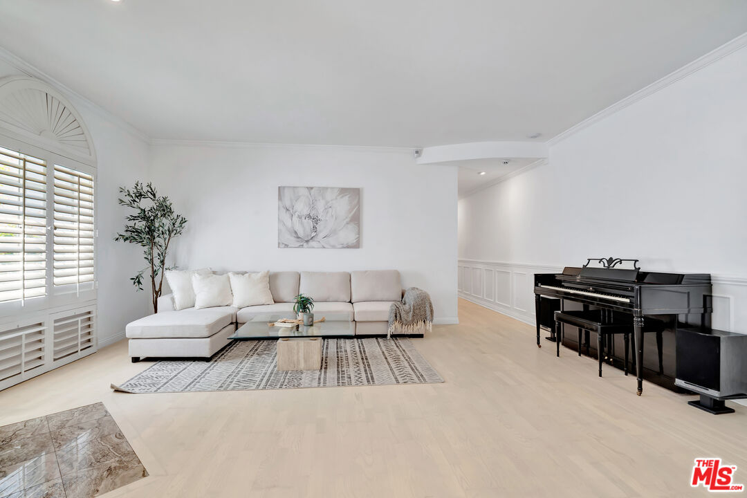 10531 Ashton Avenue, Unit 201 Los Angeles, CA 90024 - Photo 6 of 27 a living room with furniture and a flat screen tv