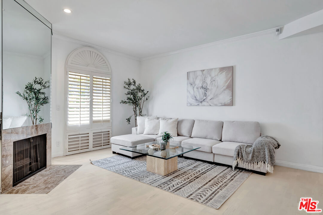 10531 Ashton Avenue, Unit 201 Los Angeles, CA 90024 - Photo 7 of 27 a living room with furniture and a fireplace