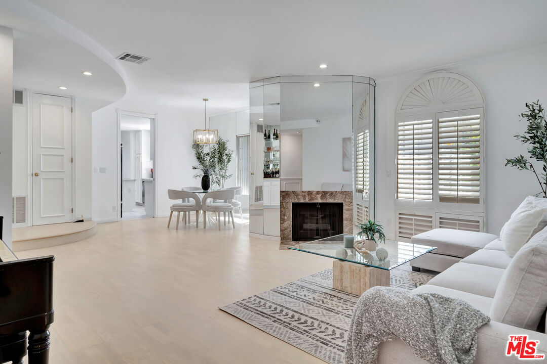 10531 Ashton Avenue, Unit 201 Los Angeles, CA 90024 - Photo 8 of 27 a living room with furniture and a fireplace