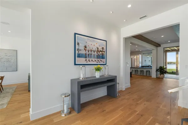 a dining room with furniture a chandelier and wooden floor