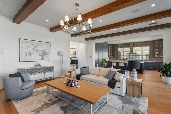 a large kitchen with a table chairs sink and cabinets
