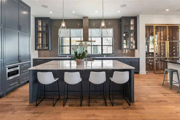 a kitchen with stainless steel appliances granite countertop sink stove and refrigerator