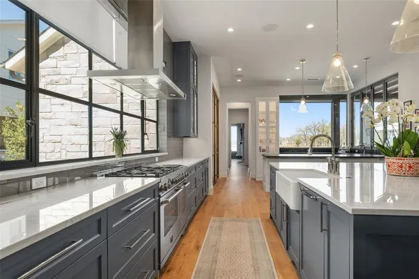 a large kitchen with cabinets table and chairs