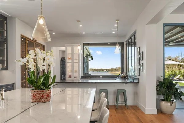 a kitchen with a large window and cabinets