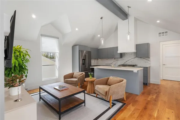 a bathroom with a granite countertop sink a toilet and shower