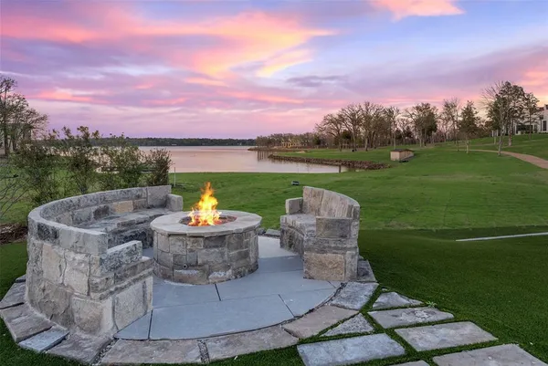 a view of a water fountain and table in the back yard