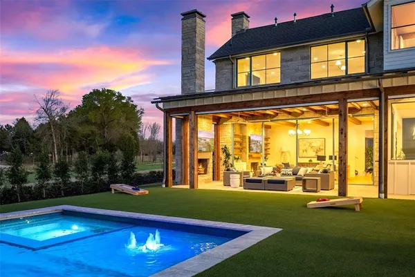 a front view of house with yard and swimming pool