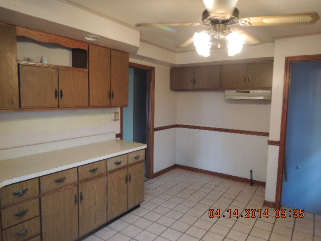 4742 South Kilpatrick Avenue Chicago, IL 60632 - Photo 13 of 21 a kitchen with cabinets and wooden floor
