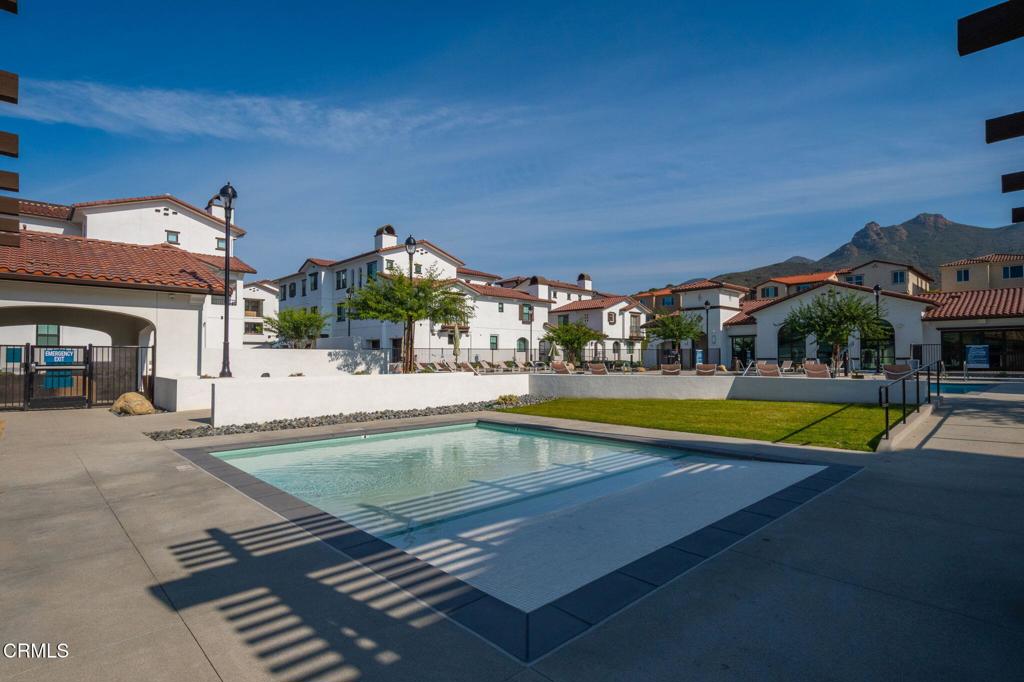 231 Inspiration Camarillo, CA 93010 - Photo 32 of 47 a view of a swimming pool with lawn chairs under an umbrella
