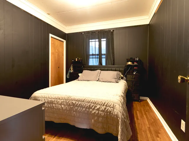 a bedroom with a bed and window