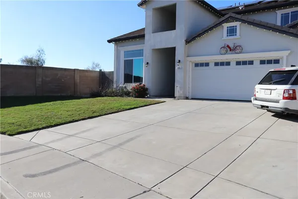 a side view of a house with a yard