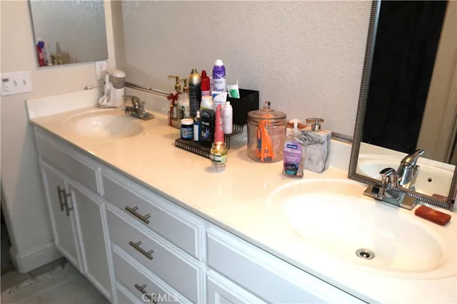 a bathroom with a double vanity sink and a mirror