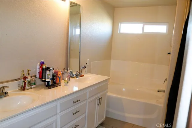 a bathroom with a double vanity sink and a mirror