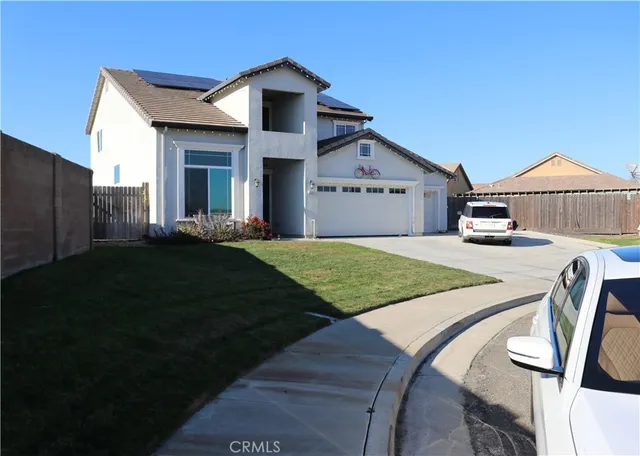 a front view of a house with yard patio and green space