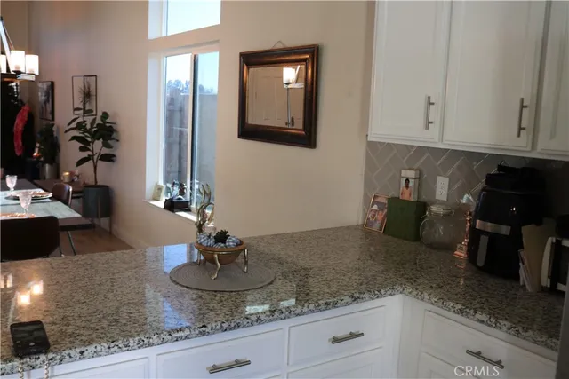 a kitchen with granite countertop a sink and a white stainless steel appliances