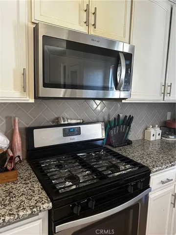a kitchen with a stove and a microwave
