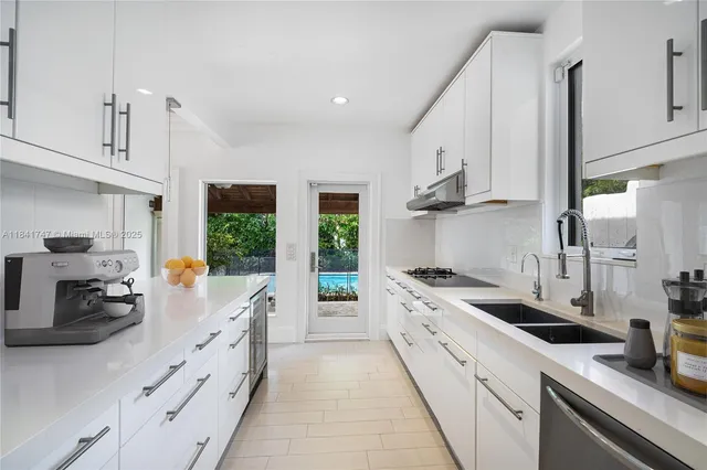 a kitchen with stainless steel appliances a sink stove and cabinets