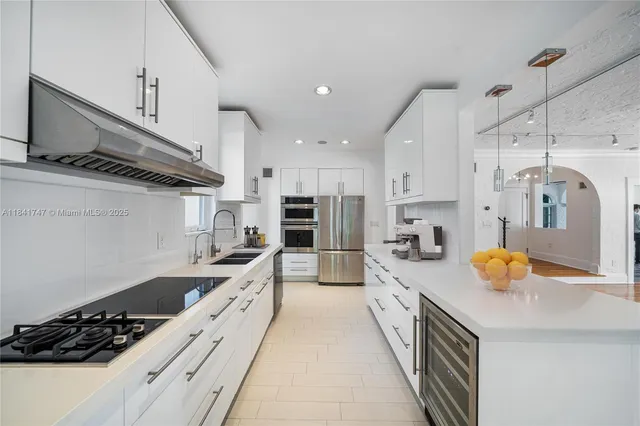 a open kitchen with stainless steel appliances granite countertop a sink a stove and a refrigerator