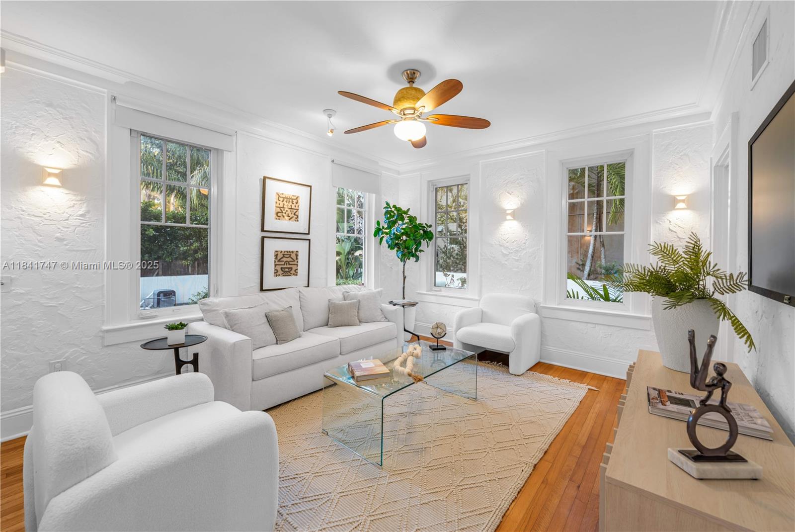 671 Northeast 57th Street Miami, FL 33137 - Photo 14 of 48 a living room with furniture a chandelier and a large window