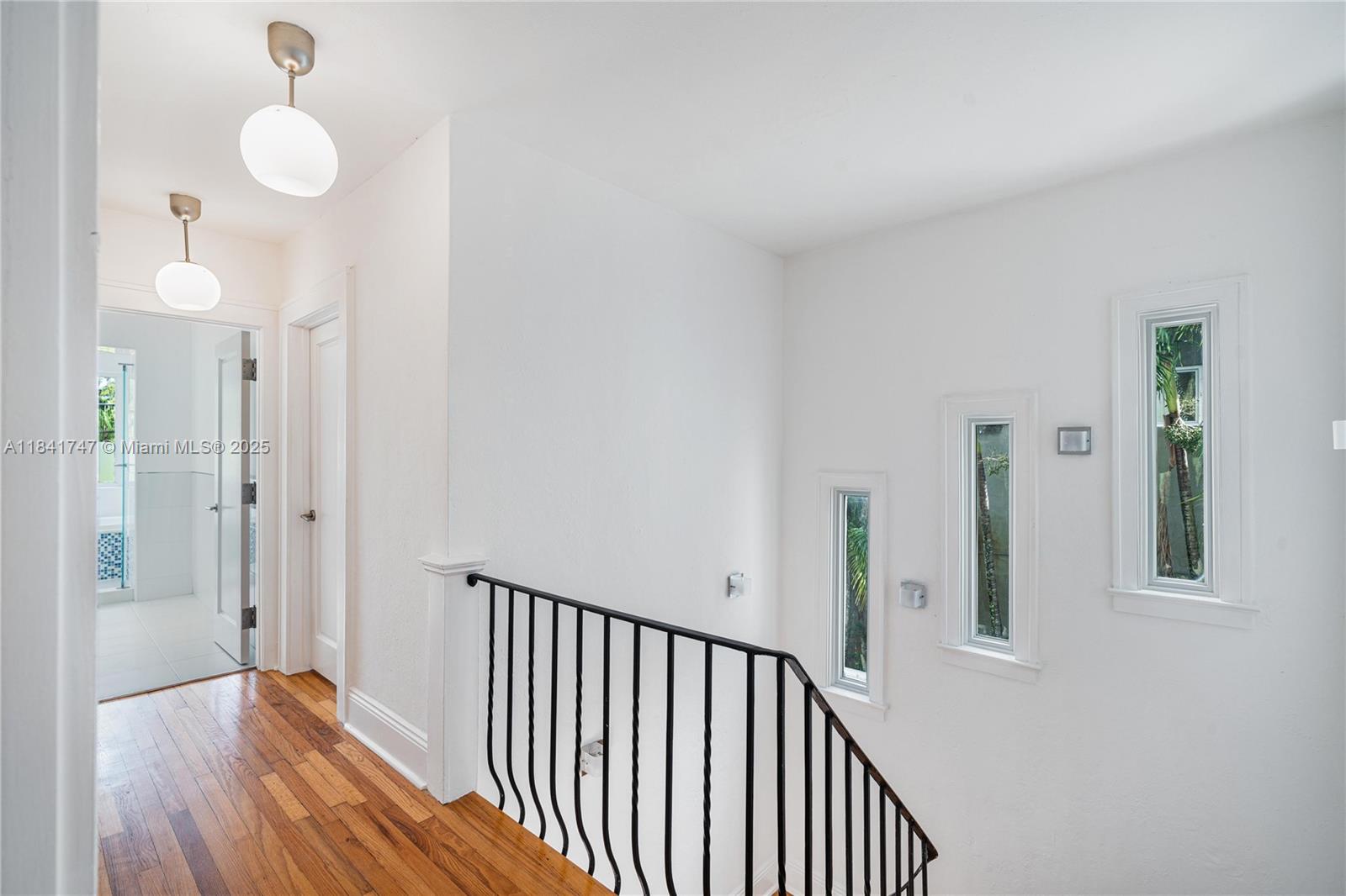 671 Northeast 57th Street Miami, FL 33137 - Photo 18 of 48 a view of a hallway with wooden floor and staircase