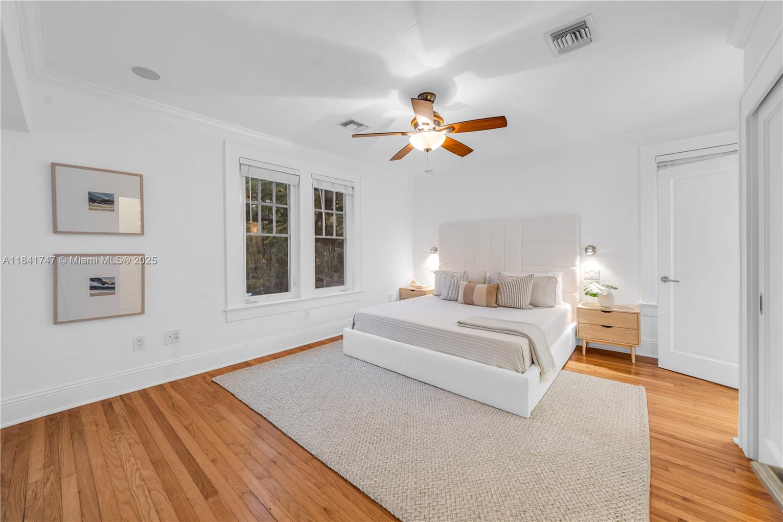 671 Northeast 57th Street Miami, FL 33137 - Photo 19 of 48 a spacious bedroom with a large bed and a chandelier