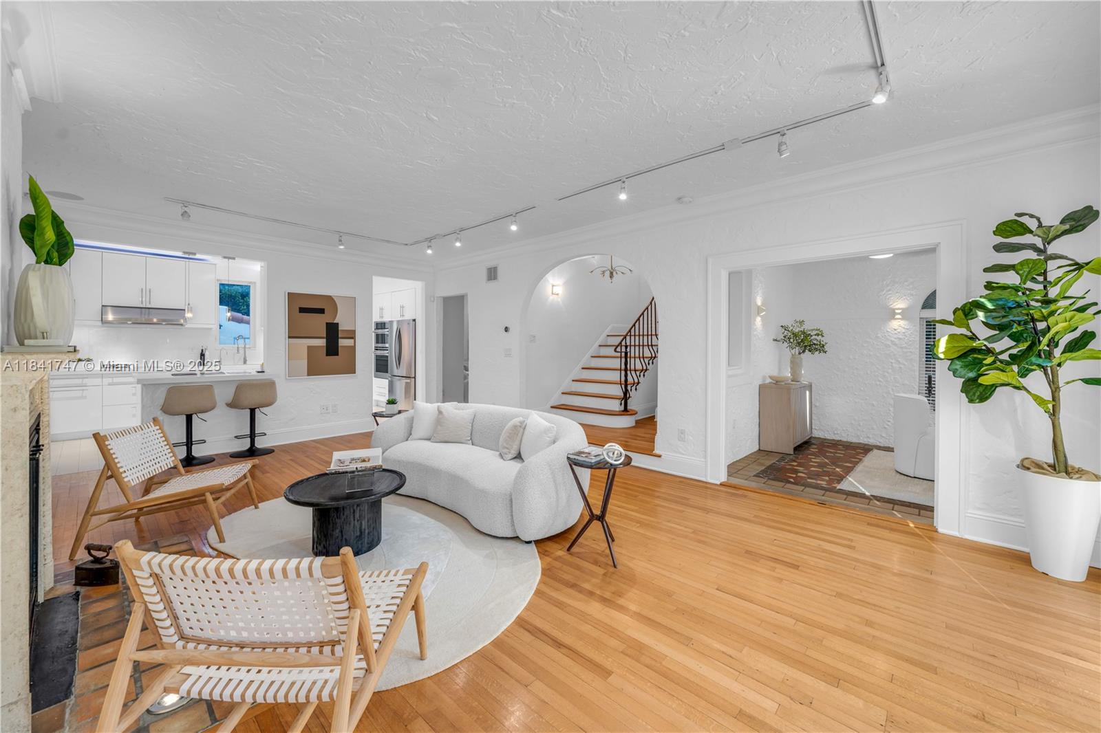 671 Northeast 57th Street Miami, FL 33137 - Photo 2 of 48 a living room with furniture and a wooden floor