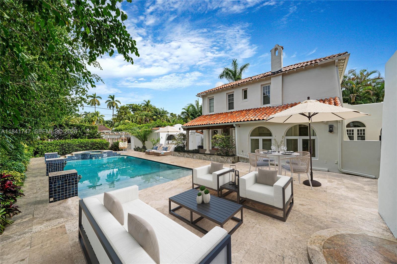 671 Northeast 57th Street Miami, FL 33137 - Photo 2 of 5 a front view of a house with garden and sitting area