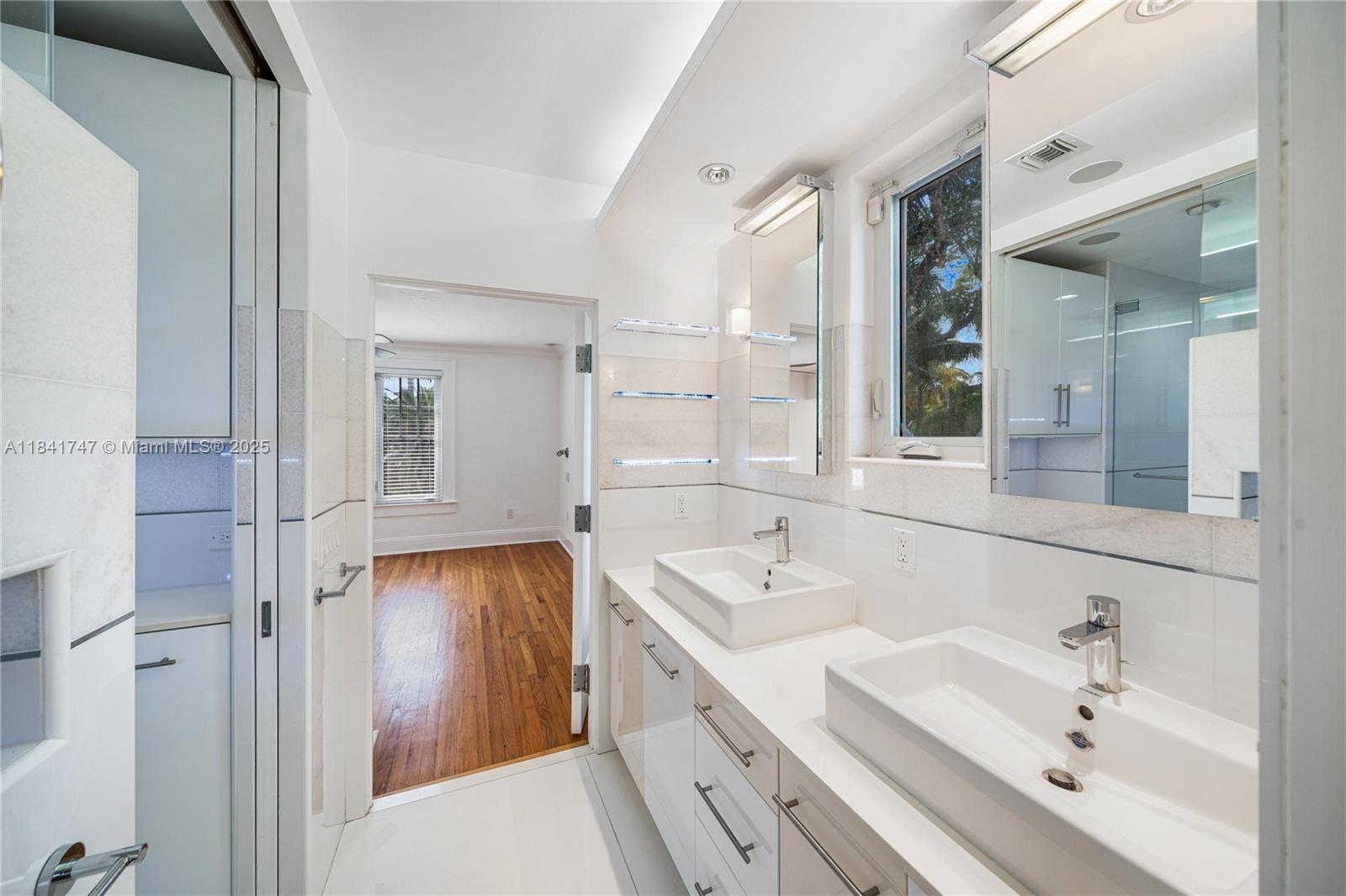 671 Northeast 57th Street Miami, FL 33137 - Photo 23 of 48 a bathroom with a double vanity sink mirror and bathtub