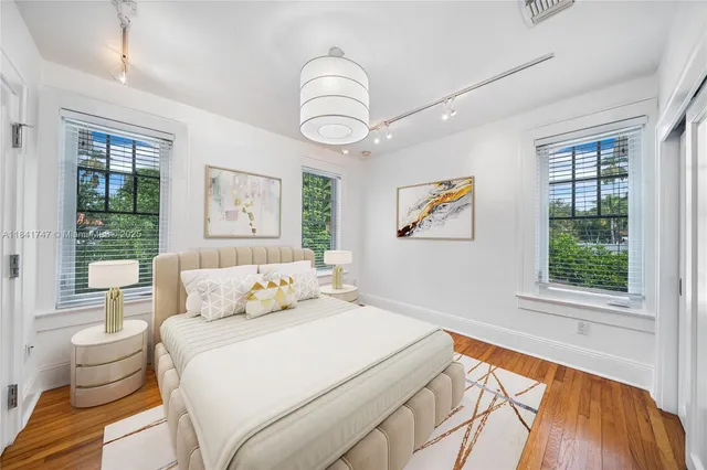 a bedroom with a bed and a large window